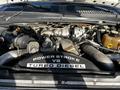 The engine compartment of a 2008 Ford F-450 SD featuring a Power Stroke V8 Turbo Diesel engine with various mechanical components visible