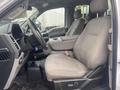 Interior of a 2017 Ford F-550 showing two gray cloth front seats with a center console and steering wheel