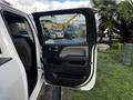 A 2017 GMC Sierra 1500 with the driver's side door open showcasing the interior features and door panel design