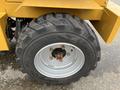 A close-up of a tire from a 2024 AGT Industrial KRW23 Mini Loader showing a rugged tread pattern and a metal rim with bolts