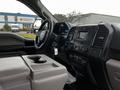 Interior view of a 2016 Ford F-150 dashboard showing the steering wheel center console and infotainment system