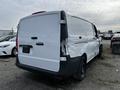 A damaged white 2018 Mercedes-Benz Metris with visible dents and scratches on the rear and side panels