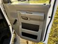 Interior side door of a 2017 Ford Econoline featuring a control handle a pull handle and storage compartments