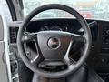 A 2016 GMC Savana steering wheel featuring the GMC logo at the center and visible dashboard elements behind it