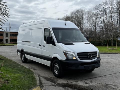 White 2016 Mercedes-Benz Sprinter van parked with a sleek design and large cargo area