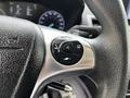 Close-up of a steering wheel control knob from a 2019 Ford Transit Connect featuring buttons for audio and cruise control settings
