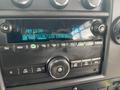 Dashboard of a 2018 Chevrolet Express featuring a radio display and control knobs for tuning and volume adjustment