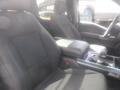 Interior of a 2022 Ford F-150 showing two front seats and a center console with armrest and gear shift