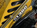 Close-up of a yellow SL 360 machinery component with a prominent black label featuring the text SL360