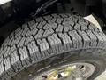 Close-up of a rugged tire tread on a 2016 Ford F-150 showcasing deep grooves and textured patterns for enhanced traction