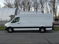 A 2019 Mercedes-Benz Sprinter van with a white exterior and black lower trim parked on a street