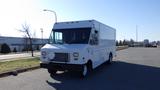 A white 2009 Ford Econoline box truck with a flat front and large cargo area, featuring multiple windows and a simple front grille design