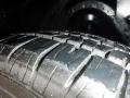 A close-up of a wet tire tread from a 1974 Dodge Challenger showcasing the deep grooves and detailed texture of the rubber