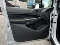 Interior door panel of a 2016 Ford Transit Connect featuring a black armrest and handle with a speaker grille at the bottom