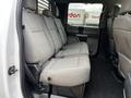 Interior view of the back seat area of a 2020 Ford F-350 with gray fabric upholstery and space for three passengers