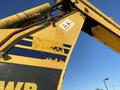 A yellow 2007 Komatsu WB156PS-5 backhoe loader with wear marks and visible decals on the side of the equipment