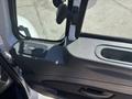 The interior door panel of a 2018 International DuraStar featuring a window control switch and a handle