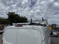 A 2023 Ford Transit van with a roof rack visible on the top