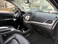 Interior view of a 2013 Dodge Journey featuring a modern dashboard with a touchscreen display and leather seats
