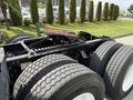 A 2012 Volvo VNL truck chassis showing large dual rear wheels and a hitch assembly with mechanical components visible