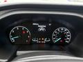 Dashboard of a 2023 Ford Transit displaying speedometer fuel gauge and various warning lights with an odometer reading of 20983.6 kilometers