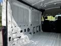 Interior of a 2021 Ford Transit van showing a spacious cargo area with white walls and a flat floor
