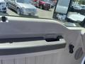 Interior door handle of a 2008 Ford F-450 SD with a gray panel and a window control switch visible next to it