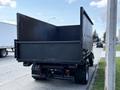 A 2009 Ford LCF 550 truck with a large open cargo bed facing the viewer showing a black exterior and no visible load