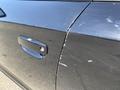 A black 2019 Dodge Charger with visible scratches and marks on the driver's side door and a shiny door handle