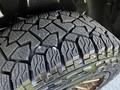 Close-up view of a rugged tire with deep treads designed for off-road use on a 2019 RAM 1500