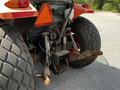 A 2011 Kubota M8540D tractor showing the rear hitch and large rear tires with visible wear and dirt