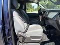 Interior view of a 2014 Ford F-250 SD showing the front seats with seatbelts and dashboard details