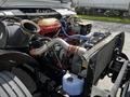 A 2022 Blue Bird BB Conventional bus engine displaying various components including hoses radiator and engine block
