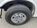 A close-up view of a chrome wheel rim with the Chevrolet logo mounted on a tire labeled Maxxis and featuring an all-terrain tread pattern