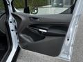 A 2019 Ford Transit Connect front door open showing the interior door panel with a handle and speaker