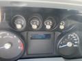 Dashboard of a 2015 Ford F-450 SD showing speedometer and gauges for oil pressure coolant temperature fuel level and battery status with an odometer reading 211639 km