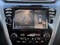 Dashboard display of a 2021 Nissan Murano showing a rearview camera with parking guidelines and a vehicle image indicating surrounding view for safety