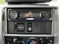 The dashboard displays a JVC stereo system in a 2020 Hino 338 featuring buttons for audio control and a digital screen showing the message no proud device