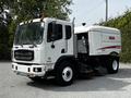 2012 Autocar Xpert street sweeper with a white exterior and cleaning equipment attached on the side