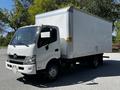 A white 2020 Hino 155 delivery truck with a boxy cargo area and a front cab featuring a black grille and headlights