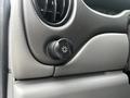 Close-up of a black knob with a sun symbol used to control the dashboard lighting in a 2008 Ford Econoline