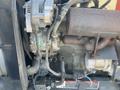 Close-up of a 2010 Kubota F3680 engine showing various components including the alternator and exhaust manifold with visible wires and connections