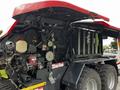 A 2020 Pottinger Impress baler showcasing its internal mechanical components including gears and rollers designed for agricultural use