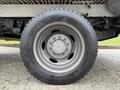 A close-up view of a silver alloy wheel and tire from a 2016 Ford F-550 Super Duty showing detailed tread patterns and a six-bolt pattern on the wheel rim