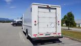 A white 2006 Ford Econoline box truck parked, showing its rear with a simple design and a small access door on the right side