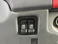 Two black buttons labeled "REAR" on a textured gray panel in the cab of a 2015 Isuzu NPR HD