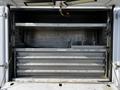 The image shows the interior storage compartments of a 2018 Ford F-550 with several metal shelves designed for equipment storage