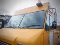 A yellow 2008 Freightliner MT45 Chassis with a large windshield and a side mirror visible on the driver's side