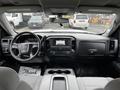 Interior view of a 2018 GMC Sierra 1500 highlighting the dashboard steering wheel and center console with controls and display screen