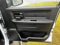 2022 RAM 1500 Classic door panel featuring a black interior with a handle power window controls and a storage compartment